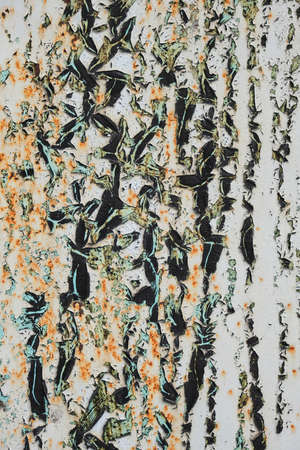 Old sheet of metal with rusty streaks and peeling paint
