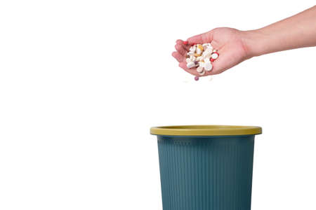 Throwing large number of pills in trash.Isolated on white backgroundの写真素材