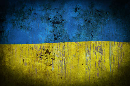 Aged flag Ukraine is depicted on an old wooden backgroundの写真素材