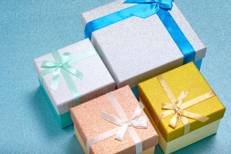 Holiday gifts in gift boxes blue shiny backgroundの写真素材