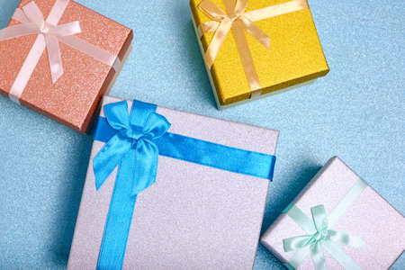 Holiday gifts in gift boxes blue shiny backgroundの写真素材
