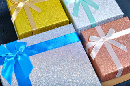 Multi colored gift boxes with bows of different colorsの写真素材