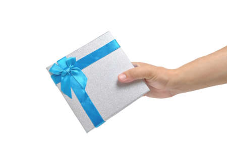 Gift box with blue ribbon and bow in hand white backgroundの写真素材