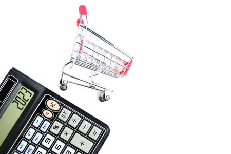 Calculator and shopping cart on white background.Concept of shopping and grocery shoppingの写真素材