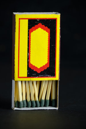 Open and full matchbox on black background