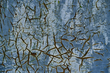 Old cracked blue paint on rusty metal surface