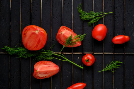 Sliced tomatoes and dill greens on grillの写真素材