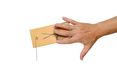 Man hand got caught in mousetrap.Isolated on white background