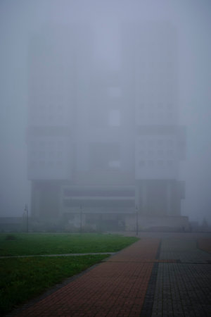 Silhouette high rise, abandoned building, drowning in fogの写真素材