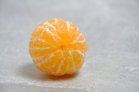 Peeled ripe tangerine gray concrete backgroundの写真素材