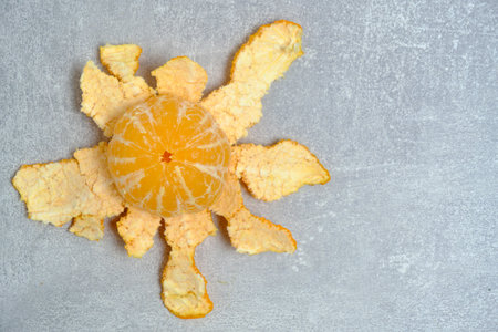 Peeled ripe tangerine gray concrete backgroundの写真素材