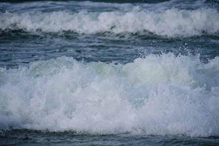 Surf wave with foam splashes on seaの写真素材