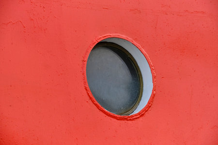Ship round porthole red background ship hull paintの写真素材