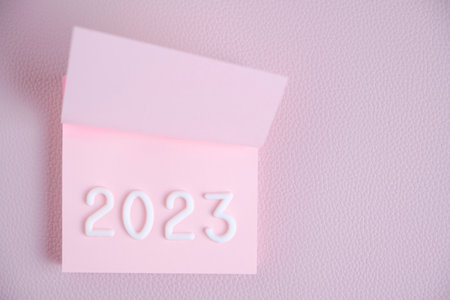 Year 2024 is laid out in white numbers pink sheet.Concept time and new year.