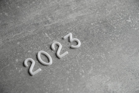Year 2023 laid out in white numbers gray concrete background