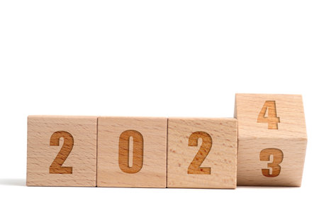 Wooden cubes made beech with inscription 2023 turning into 2024 white backgroundの写真素材