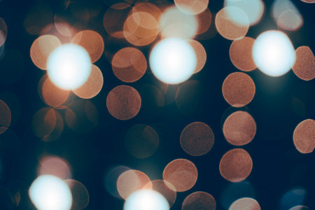 Abstract bokeh background burning light bulbs evening city and garlandsの写真素材