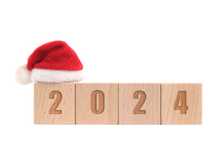 Wooden cubes with Santa hat and numbers 2024 white backgroundの写真素材