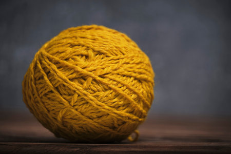 Tangle of yellow woolen threads dark gray backgroundの写真素材