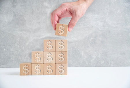 Laying out by hand steps of wooden cubes leading top.Concept growth and development businessの写真素材