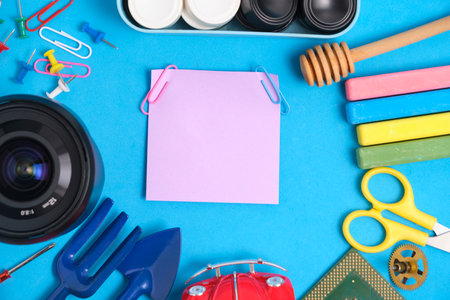 Lilac paper sticker blue background in center of a variety things for games and hobbies