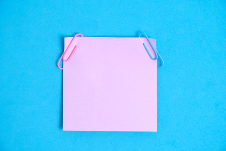 Lilac paper stickers for writing notes on a blue background