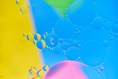 Bright abstract, multicolored background with oil circles.With blue, yellow, pink and green color.の写真素材