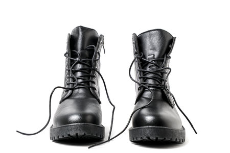 Pair black leather boots with laces white background