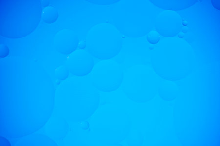 Blue abstract background with oil circles, streaks and gradientの写真素材