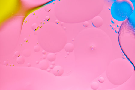 Bright abstract, multicolored background with oil circles.With blue, yellow and pink colorの写真素材