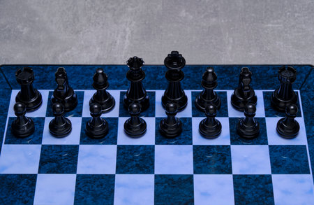 Black chess pieces chessboard with gray backgroundの写真素材