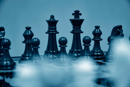 Black chess pieces background white blurred chess pieces standing chessboardの写真素材
