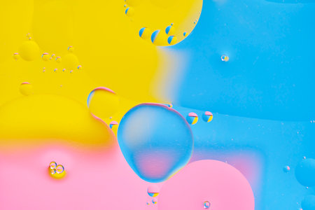 Bright abstract, multicolored background with oil circles.With blue, yellow and pink colorの写真素材