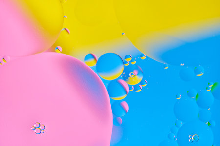 Bright abstract, multicolored background with oil circles.With blue, yellow and pink colorの写真素材