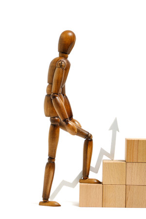 Mannequin climbs stairs to the top.Concept of development and overcomingの写真素材