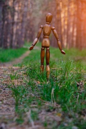 Lonely mannequin wandering through forest.Concept ecological cleanliness and relaxation from urban everyday lifeの写真素材
