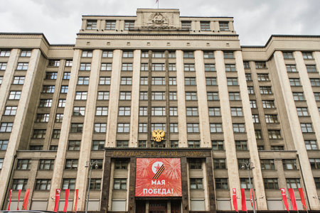 Russia Moscow 08.05.2023.Facade State Duma building with red poster May 9 is Victory Dayのeditorial素材