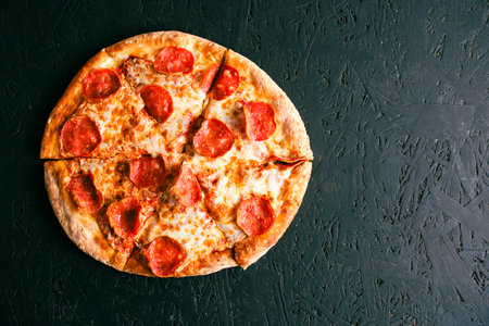 Pepperoni pizza with sausage dark backgroundの写真素材