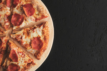 Pepperoni pizza with sausage dark backgroundの写真素材