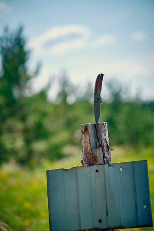 Knife is stuck in stamp tree with tin panel for text
