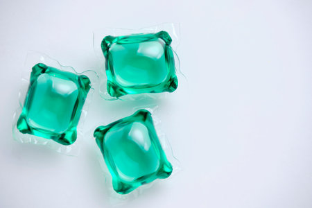 Green laundry capsules white background