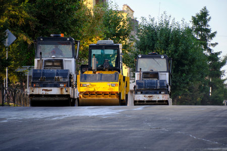Laying of new asphalt with ice rinks.Road construction equipment is working.Repair old road