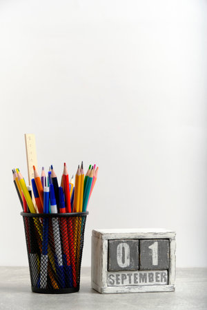 Organizer with pencils and ruler, stationery stand and wooden calendar with date September 01の写真素材