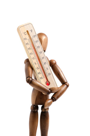 Wooden mannequin holds street thermometer white background closeupの写真素材