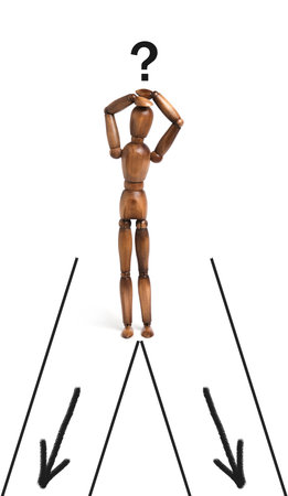 Mannequin stands road diverging right and left.Concept of decision making in life and businessの写真素材