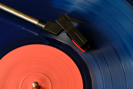 Blue vinyl record and needle for playing music from vinyl top view