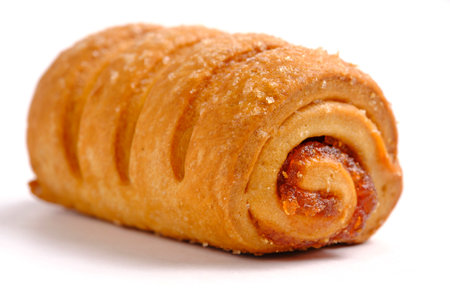 Roll roll with jam sprinkled with sugar, confectionery and pastries. On white backgroundの写真素材