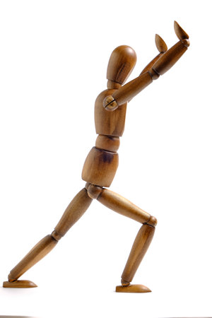 Wooden mannequin white background in restraining position with his handsの写真素材