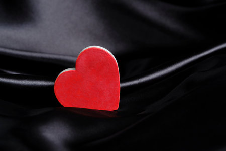 Heart on background black silk fabric. Concept Valentines Day.の写真素材