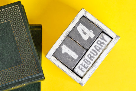 February 14th on the calendar and books on yellow background. International book giving dayの写真素材